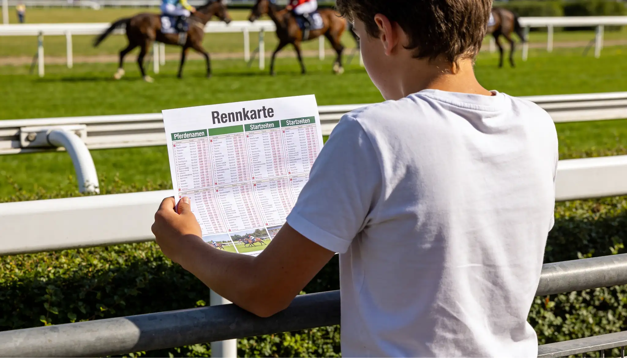 Anfänger studiert eine Racecard vor einem Pferderennen auf der Rennbahn
